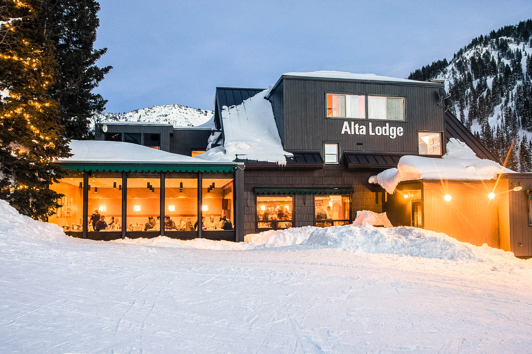 Looking into the bright lights of the Alta Lodge dining room in the evening, from the rope tow hill.