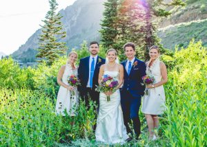 Bride with bridesmaids and groomsman in the mountains